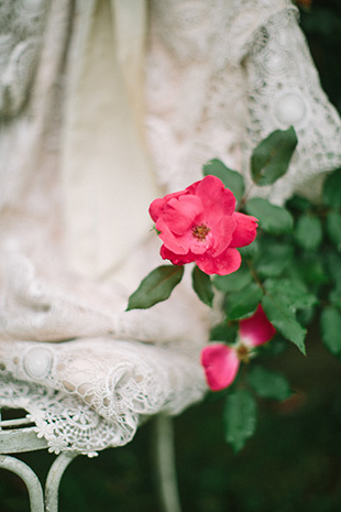 pink flowers and lace wedding dress