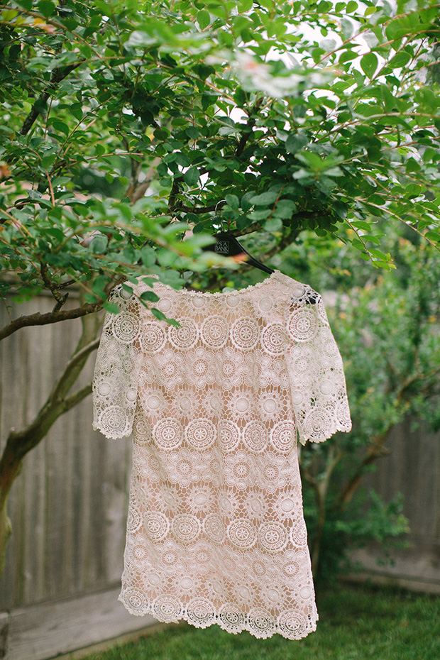 lace weddign dress hanging in tree