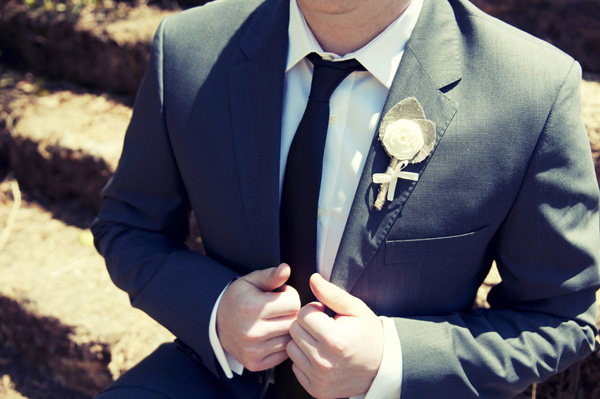 groom with canvas flower boutonniere