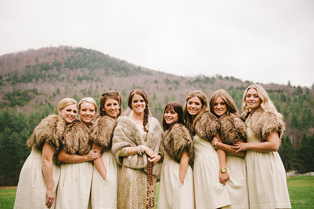 bride and bridesmaids wearing fur shawls