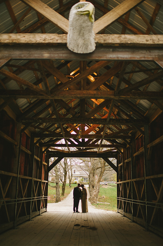 bride and groom in a farm yard tunnel