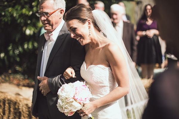 father of the bride walking the bride down the ailse