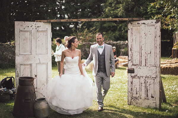 bride and groom walking through vintage door archway