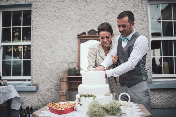 bride and groom cutting the cake