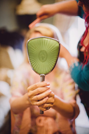 bride holding mirror