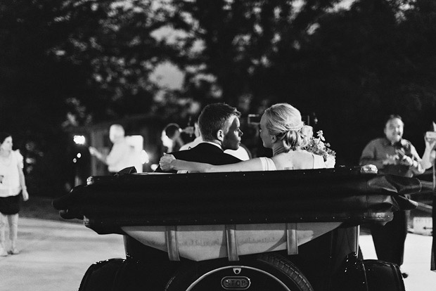 bride and groom in getaway car