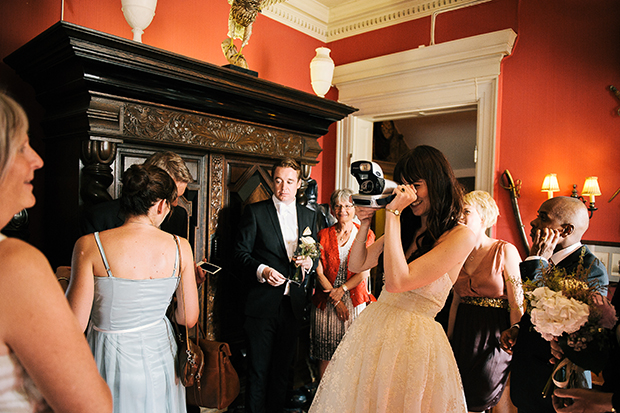 bride with polaroid camera