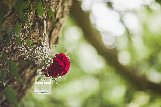 Pretty hanging jars with flowers for an outdoor wedding ceremony | onefabday.com