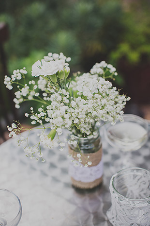 mason jar with simple blooms trimmed with burlap and lace | onefabday.com