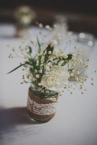 mason jar with simple blooms trimmed with burlap and lace | onefabday.com