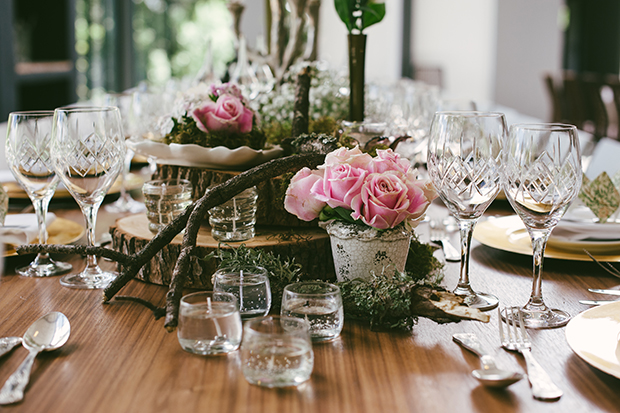 pink roses and tree stump table decor