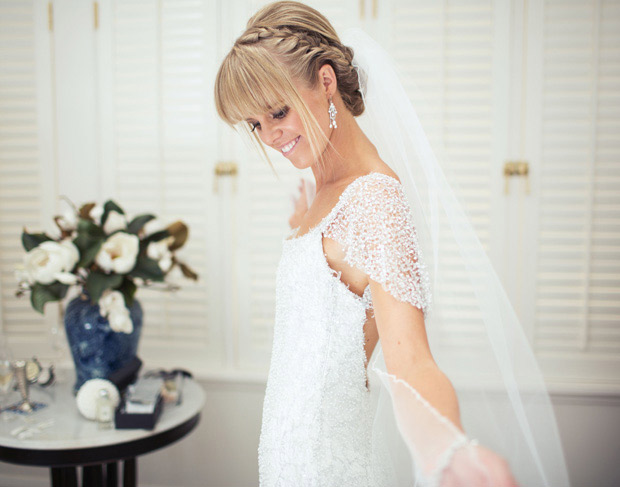 Bride with beautiful beaded dress and cathedral length veil | onefabday.com