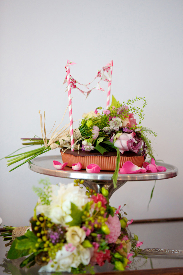 pretty wedding cake with florals and bunting | onefabday.com