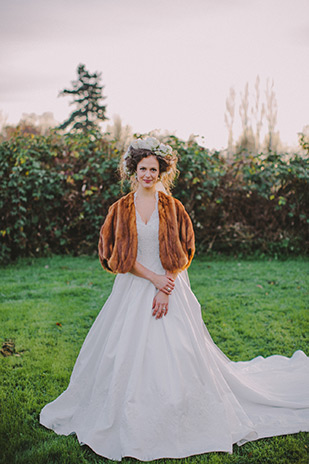 bride in fur jacket and floral hair garland | onefabday.com