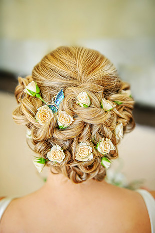 Bridal hair dotted with mini roses | Clio and Dave's beautiful botanical inspired wedding at Kilshane House by Give Us A Goo Photography | onefabday.com