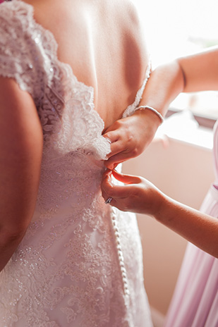 button detail wedding dress | Paul and Ann's pretty barn wedding at Larchfield | onefabday.com