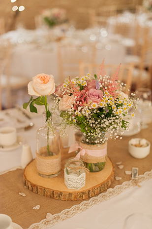 Pastel rustic table centrepieces | Paul and Ann's pretty barn wedding at Larchfield | onefabday.com