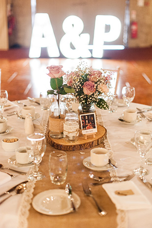 Pastel rustic table centrepieces | Paul and Ann's pretty barn wedding at Larchfield | onefabday.com