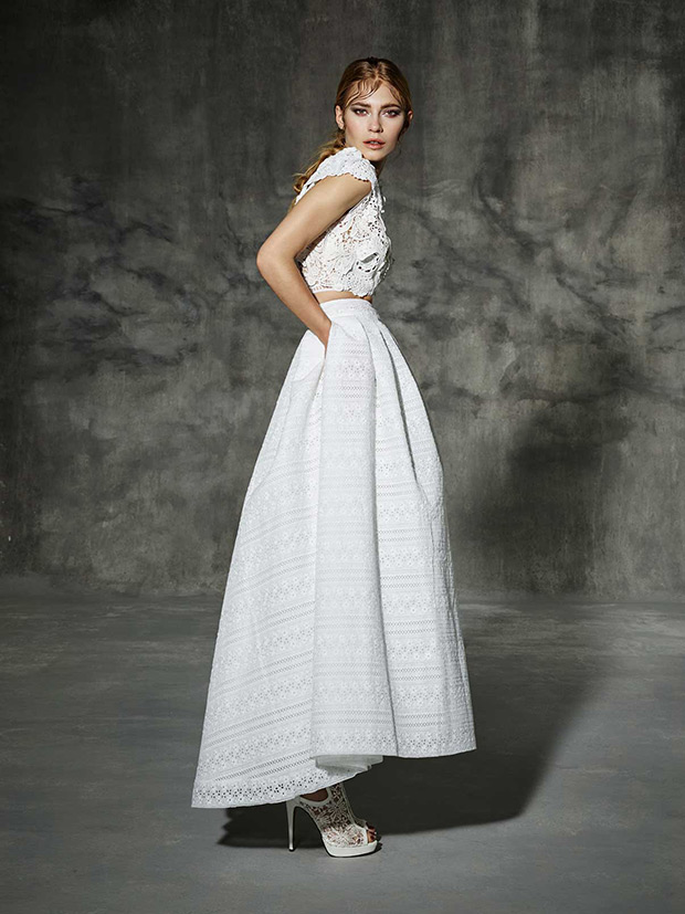 Calabria from Yolan Cris wedding dresses 2016 -2-pieces bridal gown made in pure white natural cotton fibers. Handmade bridal top mde of different natural laces and silk flowers. Fancy ankle-lenght skirt with side pockets and slightly lower at the back.-  see the rest of the collection on onefabday.com