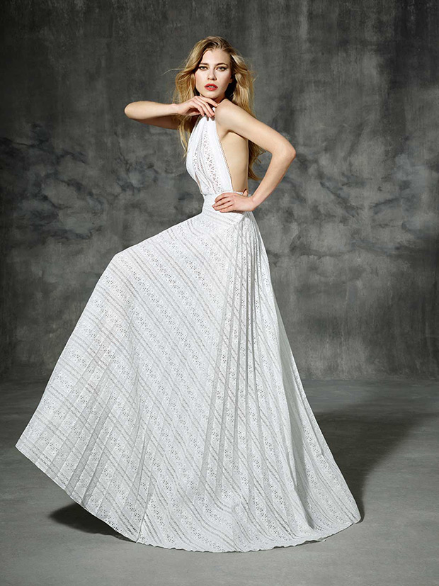 Lesseps from Yolan Cris wedding dresses 2016 -A pure white pleated soleil lace. and halter neckline with triangle-shaped cutout.It has a stylish backless bohemian bridal design -  see the rest of the collection on onefabday.com