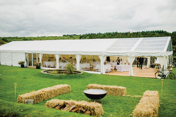 Flower-filled marquee Mussenden temple wedding in Ireland by NavyBlur Photography // onefabday.com