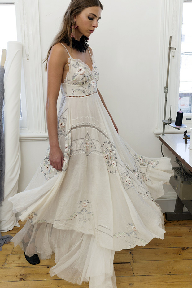 Style 37 from Nevenka wedding dresses 2017 -V-neck line with shoe string straps, embroidered colored detialing on the bodice and cut out detailing on the skirt. Layered free flowing skirt. -  see the rest of the collection on onefabday.com