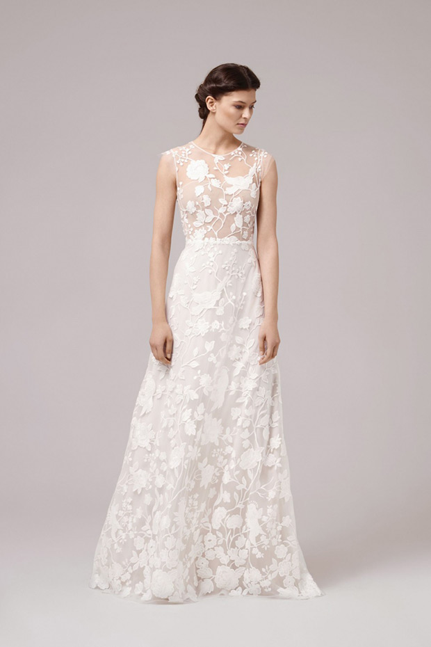 March Gown from Anna Kara wedding dresses 2017 - Fitted sheer bodice with floral applique designs. Natural waist line with a layered skirt with a floral lace overlay- see the rest of the collection on onefabday.com