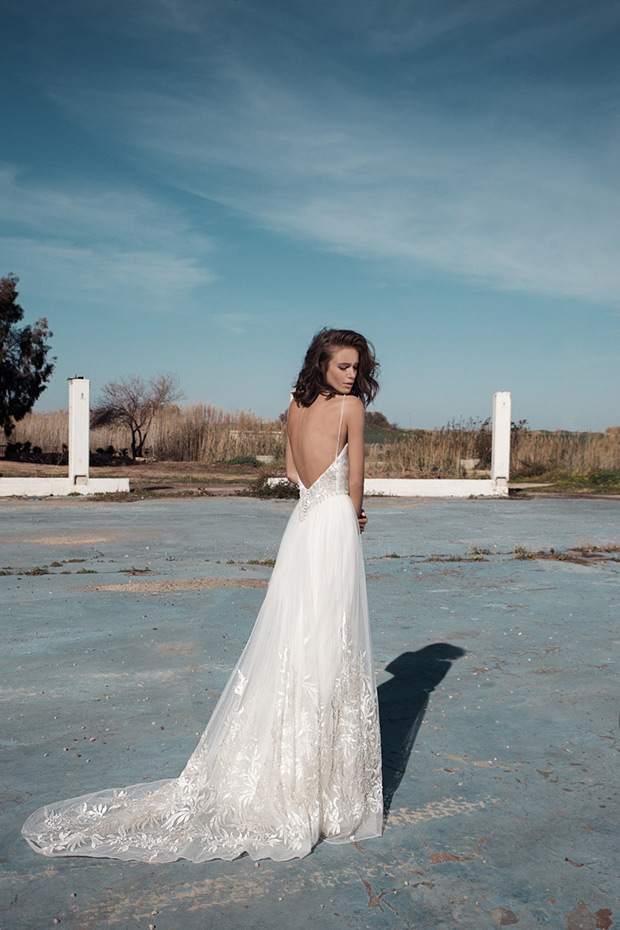 Carrie back from Flora  wedding dresses 2018 - Deep open back with a natural waist. Layered skirt with an overlay of embroidered detailing. Shoe string straps-  see the rest of the collection on onefabday.com