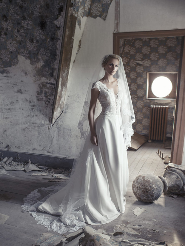 Calista-Cymbeline-Le-Chateau-de-Crevecouer-2018- V-neckline with a sheer panel. Embroidered lace detailing with a full ballroom gown and delicate veil. To see more visit onefabday.com 