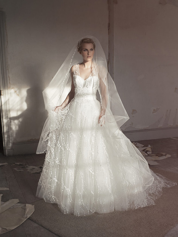 Cathy-Cymbeline-Le-Chateau-de-Crevecouer-2018-Sweetheart neckline with a sheer panel strap. Full layered tulle skirt with an embroidered pearl detailing. Veil with lace detailing. To see more visit onefabday.com