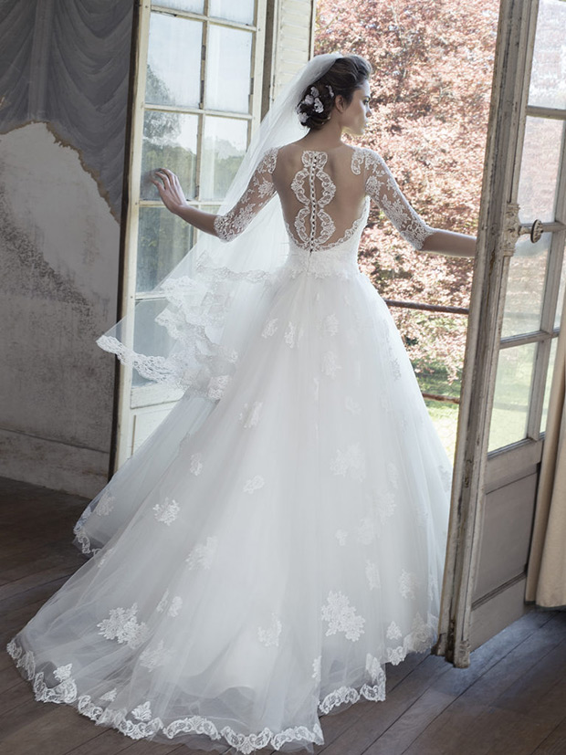 Chateline-Cymbeline-Le-Chateau-de-Crevecouer-2018- Sweetheart neckline bodice with sheer lace detailed sleeves. Full princess skirt with a lace embroidered over lay.Sheer open back panel with embroidered detailing. To see more visit onefabday.com