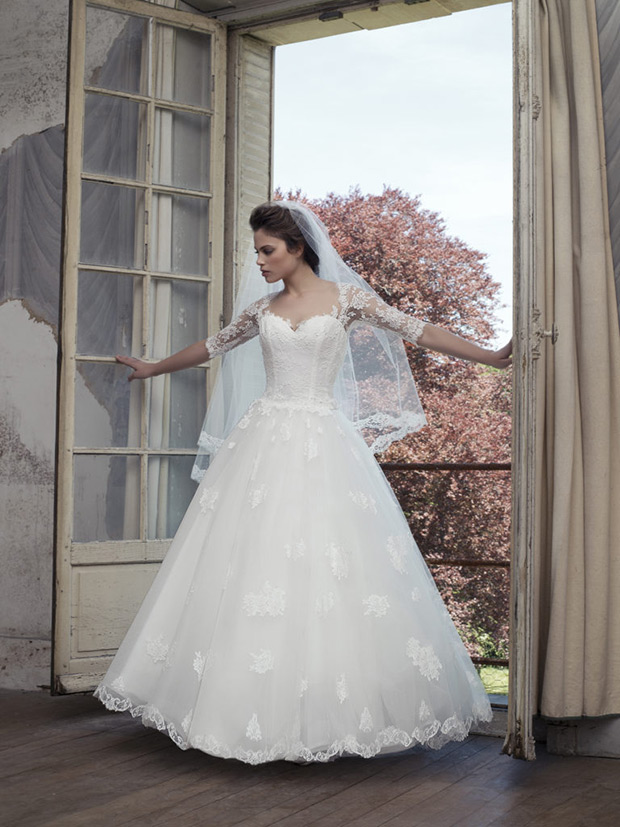 Chateline-Cymbeline-Le-Chateau-de-Crevecouer-2018- Sweetheart neckline bodice with sheer lace detailed sleeves. Full princess skirt with a lace embroidered over lay. To see more visit onefabday.com