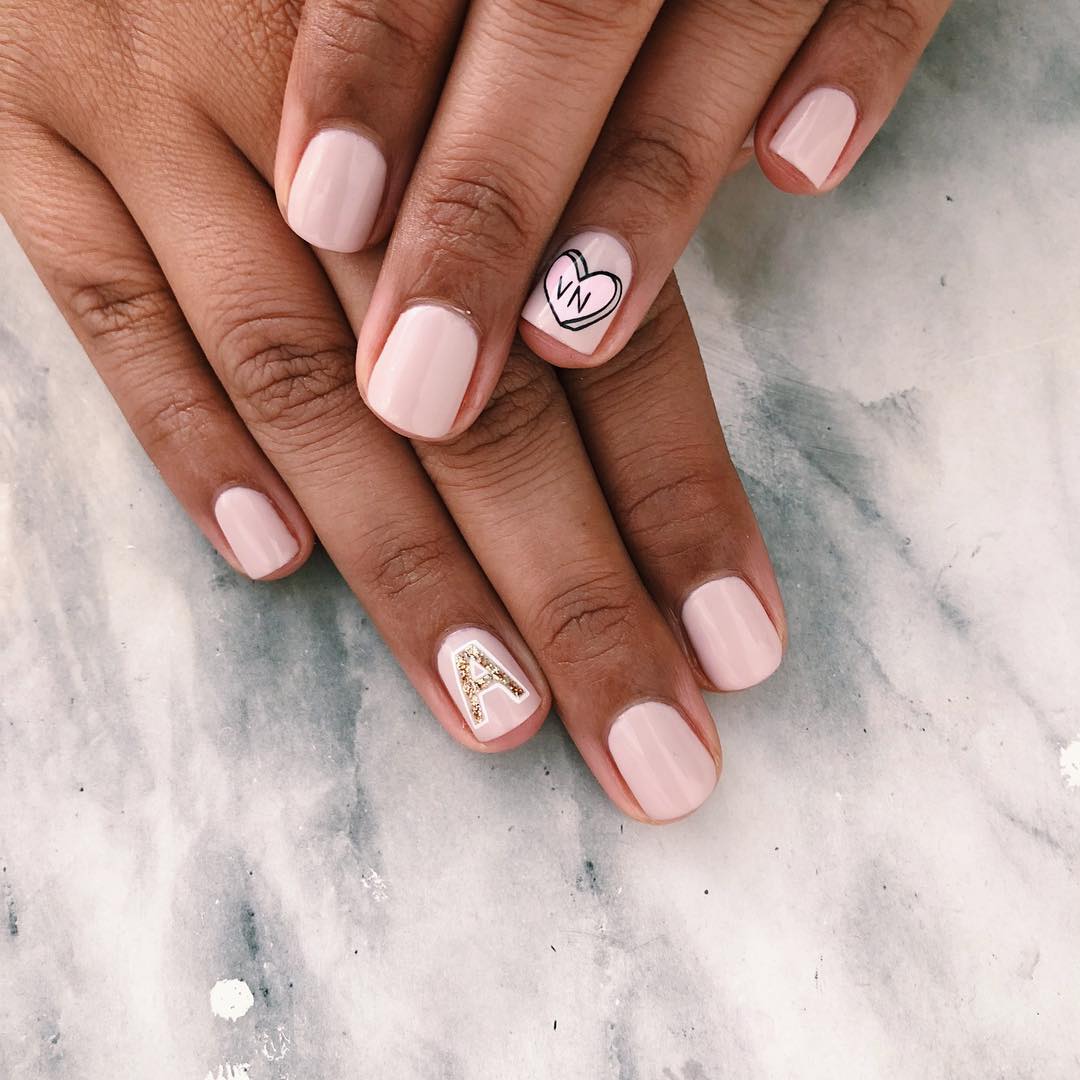 Pale pink nails with heart and initials to personalise them