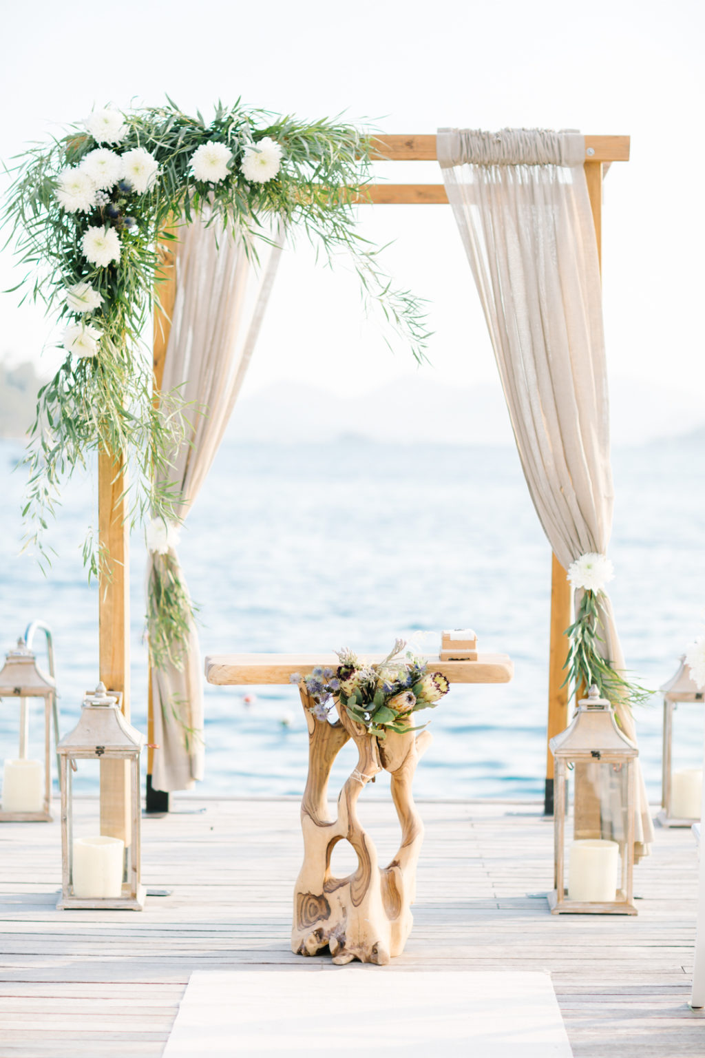 outdoor seaside wedding ceremony, canopy, floral arch