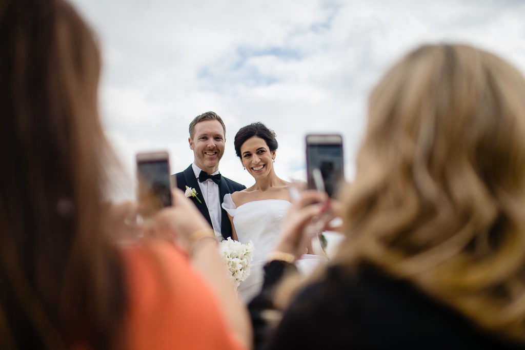 wedding guests taking photographs smartphone