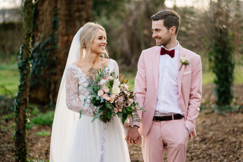 pink groom suit, colourful groom style, Anna Geogina wedding dress, long sleeve wedding dress, lace wedding dress