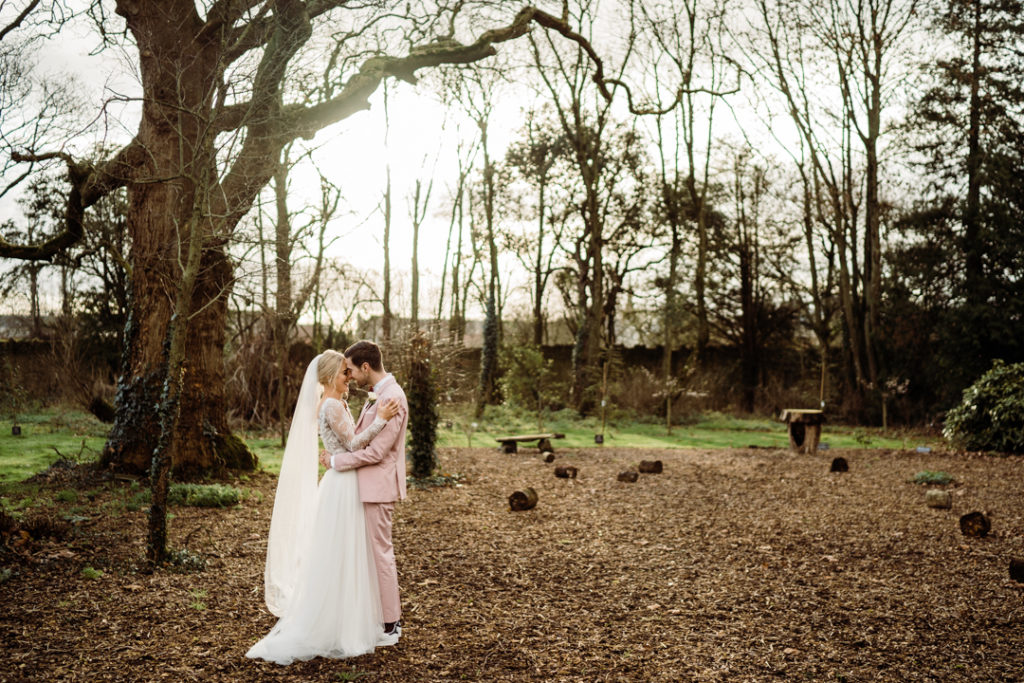 pink groom suit, colourful groom style, Anna Geogina wedding dress, long sleeve wedding dress, lace wedding dress