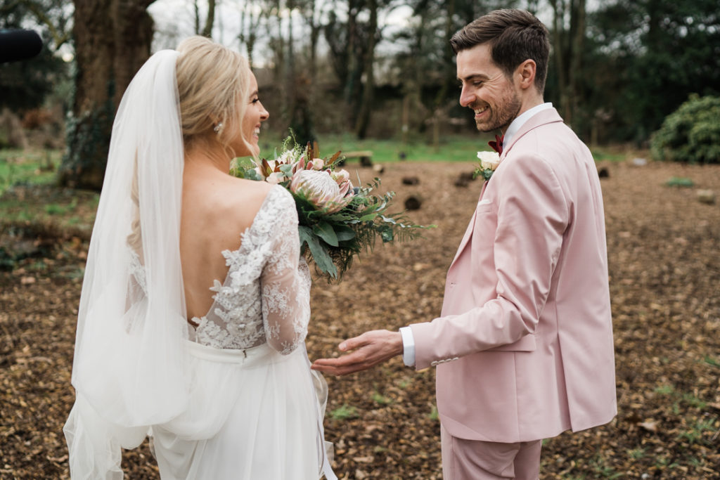 pink groom suit, colourful groom style, Anna Geogina wedding dress, long sleeve wedding dress, lace wedding dress