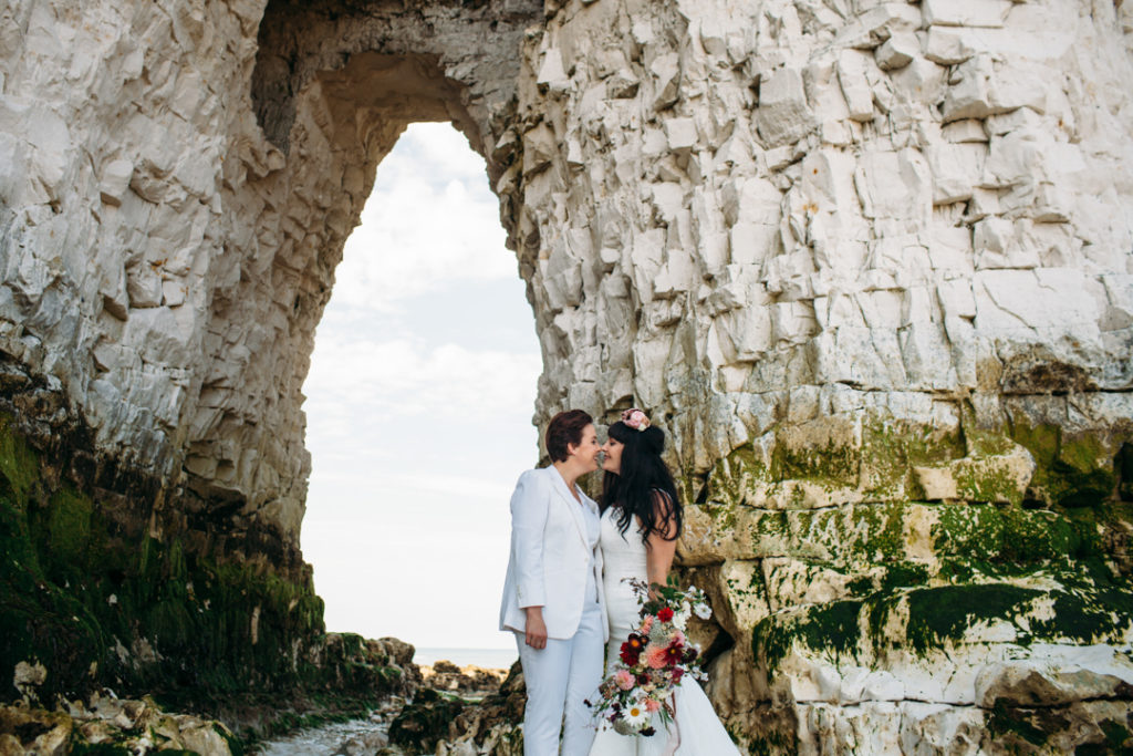 flower crown bride, bridal suit, white wedding suit bride, Beach wedding in Margate UK by Joanna Bongard, oversized floral bouquet