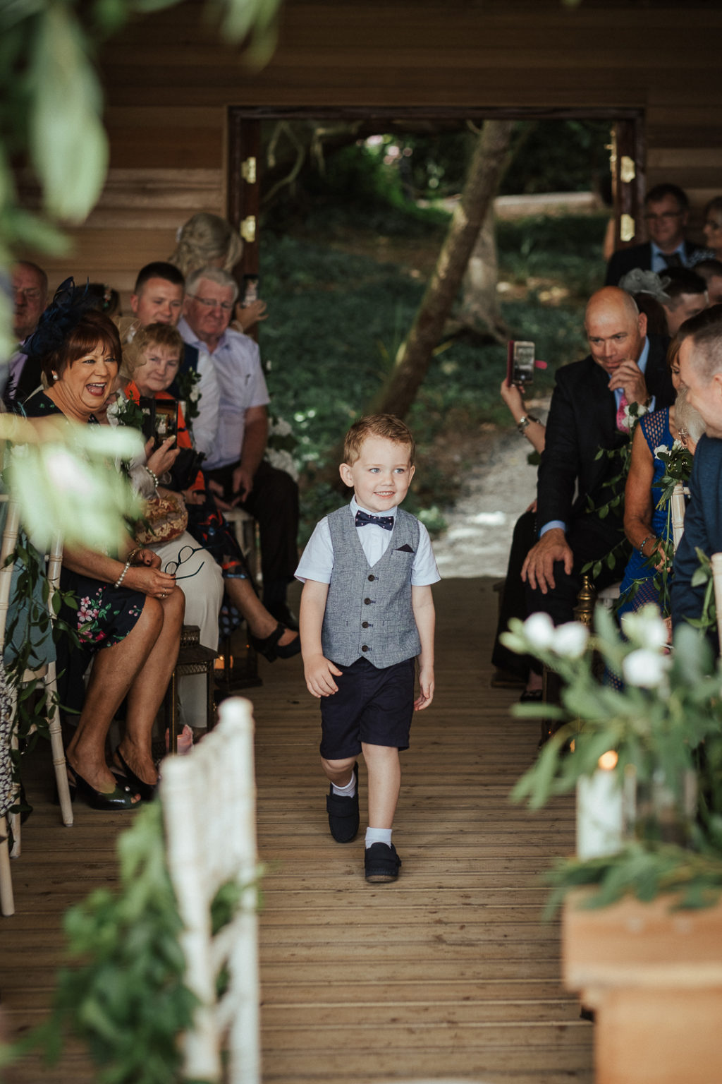 Ashley Park House ceremony space, ceremony arch, floral moon gate, greenery arch, page boy style, comfortable page boy outfit