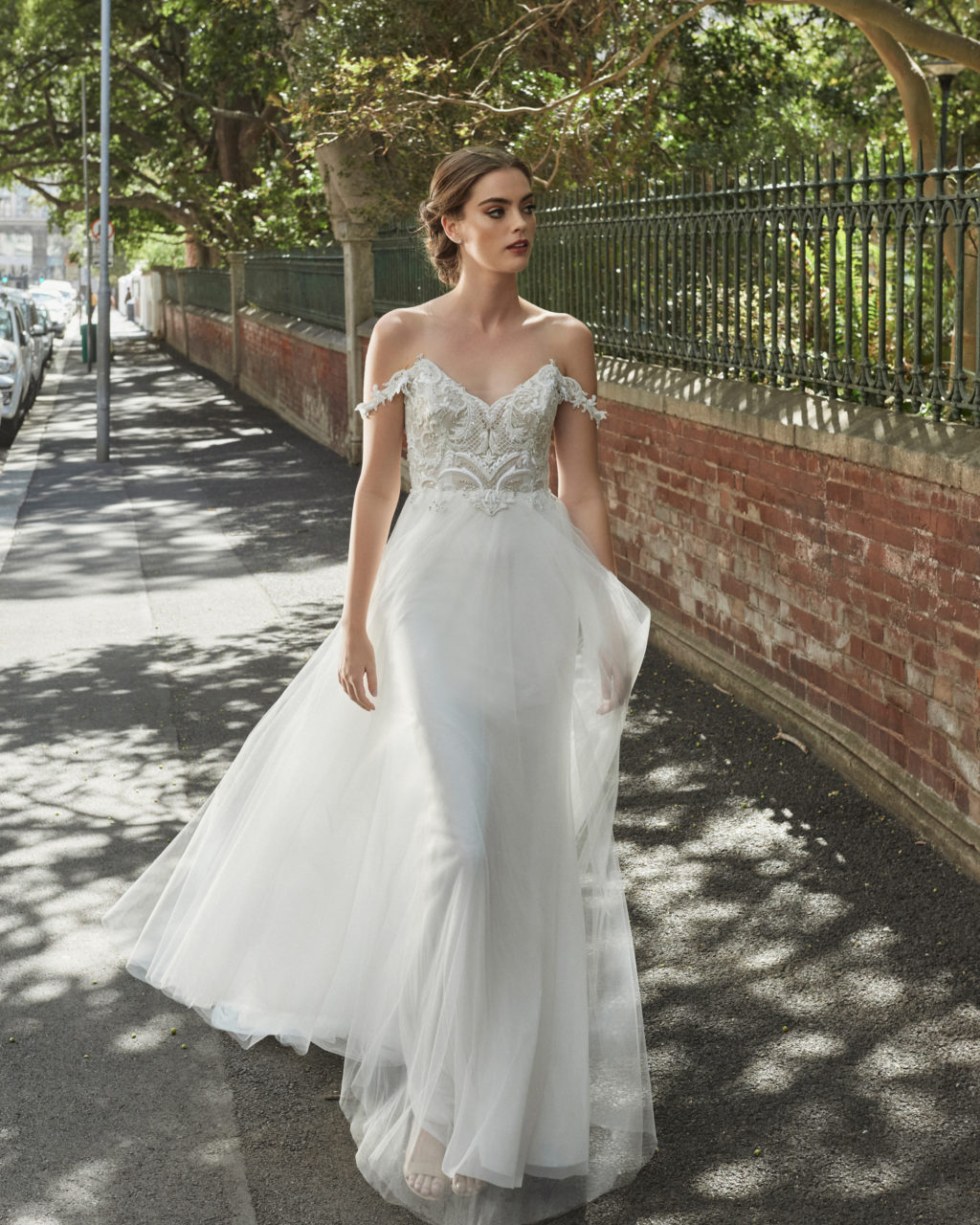 A little off the shoulder wedding dress with beading and a flowing overskirtElbeth Gillis Wedding Dresses 2021