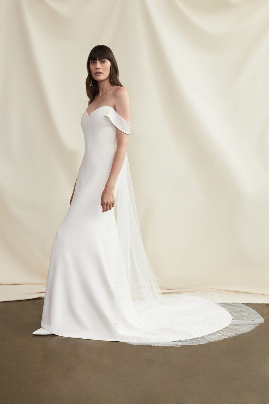 Off the shoulder wedding dress - the Winona from the Savannah Miller 2021 collection The Lady of the Lake. See more at 