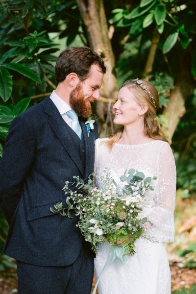 Exterior couple forest green trees bride groom photography looking at each other