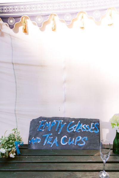 Empty glasses & tea cups sign in tent