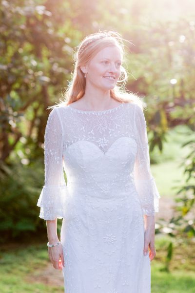 Bride smiling dress detail sunlight sunshine