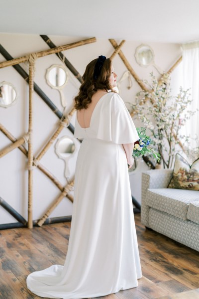 Bride holding bouquet of flowers roses interior shot