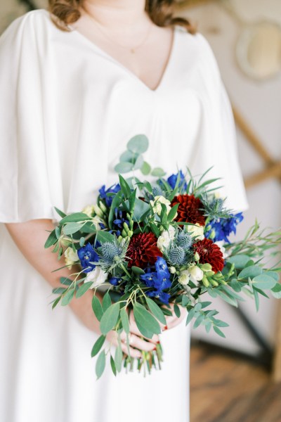 Close up of bride holding bouquet of flowers roses