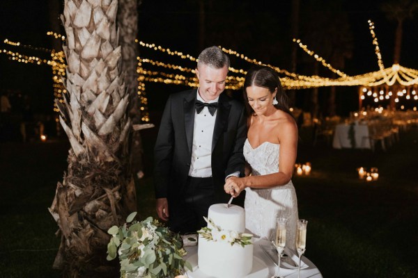 bride and groom cutting cake