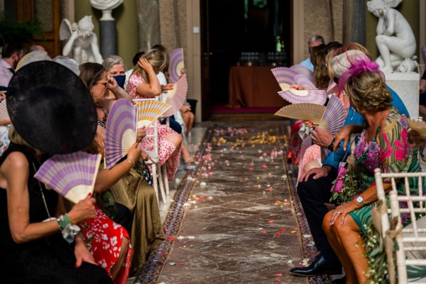 Wedding photography Jane & Alex guests fans confetti colourful dresses ceremony