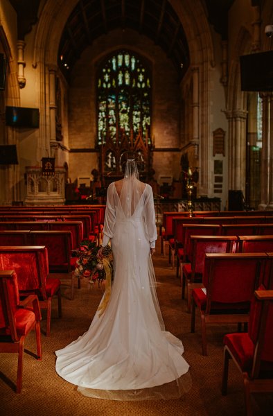 bride in church long sleeved dress